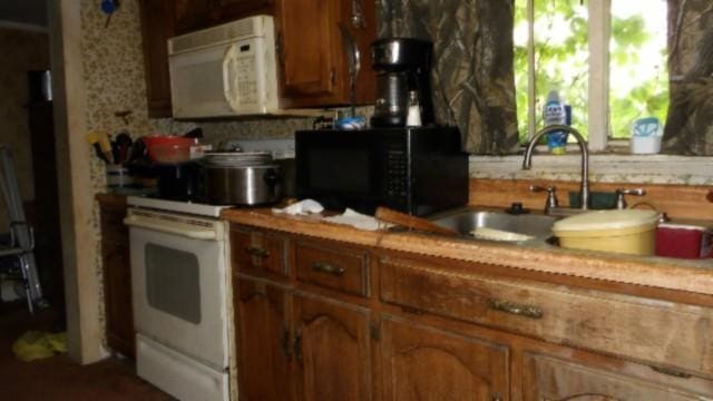 105 Log Home Ln, Moss, TN 38575 - kitchen with white appliances, light countertops, and brown cabinets