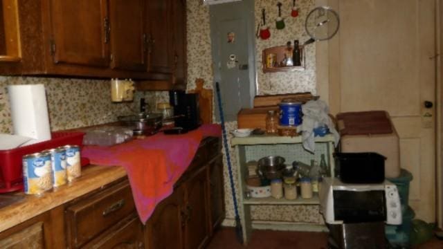 105 Log Home Ln, Moss, TN 38575 - kitchen featuring brown cabinetry and backsplash
