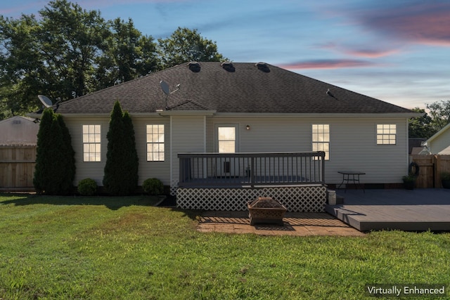 1902 Vicksburg Cir, Columbia, TN 38401 - back of house at dusk with a fire pit, a wooden deck, and a shingled roof