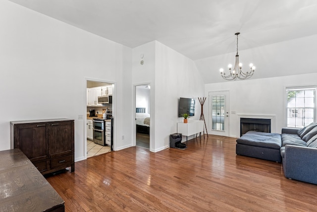 1902 Vicksburg Cir, Columbia, TN 38401 - living area with light wood-type flooring, high vaulted ceiling, a chandelier, and a fireplace