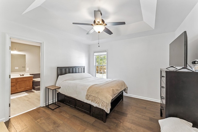 1902 Vicksburg Cir, Columbia, TN 38401 - bedroom featuring dark wood finished floors, a tray ceiling, ensuite bath, and a ceiling fan