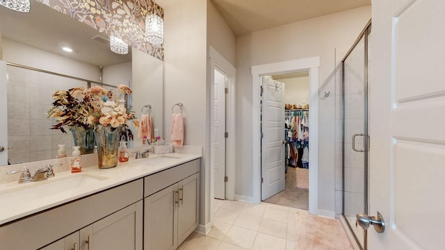 308 Whisper Wood Way, Lebanon, TN 37087 - bathroom featuring a shower stall, double vanity, tile patterned flooring, and a spacious closet