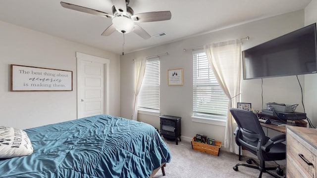 308 Whisper Wood Way, Lebanon, TN 37087 - bedroom with light carpet, a desk, ceiling fan, and a wood stove
