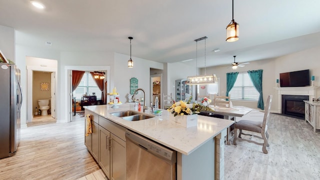 308 Whisper Wood Way, Lebanon, TN 37087 - kitchen with stainless steel appliances, open floor plan, light wood-style flooring, and plenty of natural light