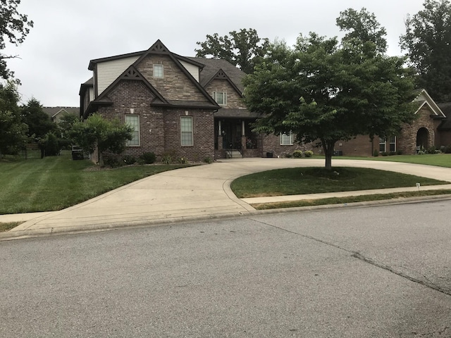 2955 Prince Dr, Clarksville, TN 37043 - craftsman house featuring brick siding, curved driveway, and a front lawn