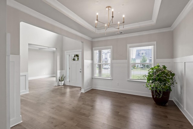 10787 Prairie Lake Dr, Apison, TN 37302 - foyer with a tray ceiling, crown molding, a chandelier, a wainscoted wall, and wood finished floors