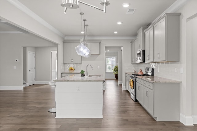 10787 Prairie Lake Dr, Apison, TN 37302 - kitchen with stainless steel appliances, tasteful backsplash, light stone countertops, crown molding, and a center island with sink