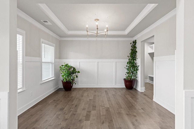 10787 Prairie Lake Dr, Apison, TN 37302 - spare room featuring a tray ceiling, a chandelier, wood finished floors, a decorative wall, and ornamental molding