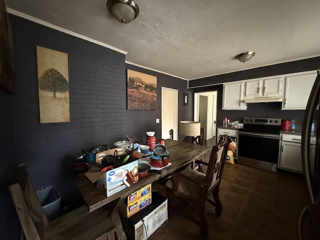 234 Ridgewood Ave, Paducah, KY 42001 - dining space featuring crown molding, dark tile patterned floors, a textured ceiling, and brick wall