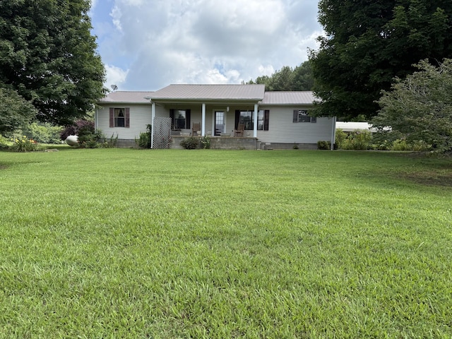 46 Brier Hill Rd, Ethridge, TN 38456 - view of front of house with covered porch, a front lawn, and a metal roof