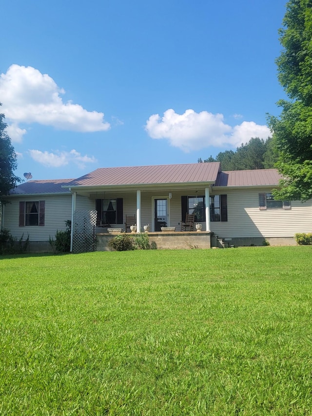 46 Brier Hill Rd, Ethridge, TN 38456 - view of front of home featuring a porch, a front lawn, and a metal roof