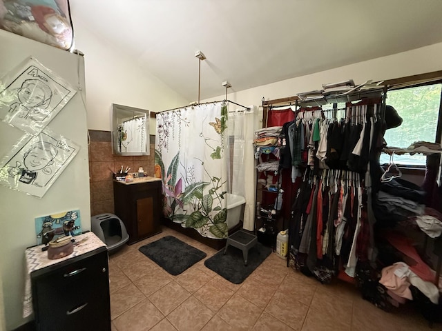 180 Webb Rd, Summertown, TN 38483 - full bathroom with tile patterned floors, lofted ceiling, a shower with curtain, vanity, and a walk in closet