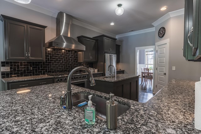 1652 Lantana Dr, Thompsons Station, TN 37179 - kitchen with wall chimney exhaust hood, decorative backsplash, dark stone countertops, ornamental molding, and stainless steel appliances