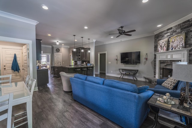 1652 Lantana Dr, Thompsons Station, TN 37179 - living area featuring crown molding, a ceiling fan, recessed lighting, dark wood-style flooring, and a stone fireplace