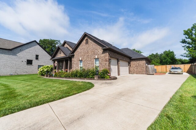 1652 Lantana Dr, Thompsons Station, TN 37179 - view of front facade with brick siding, concrete driveway, an attached garage, and a shingled roof