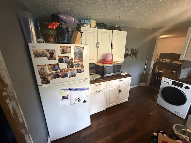 2317 Howell St, Cleveland, TN 37323 - kitchen with washer / clothes dryer, freestanding refrigerator, dark wood-type flooring, white cabinets, and a textured ceiling
