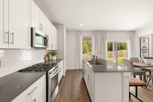 7212 Hanworth St, Fairview, TN 37062 - kitchen with appliances with stainless steel finishes, dark countertops, dark wood-type flooring, decorative backsplash, and recessed lighting