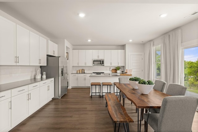 7212 Hanworth St, Fairview, TN 37062 - kitchen with stainless steel appliances, recessed lighting, backsplash, dark wood-style flooring, and white cabinets