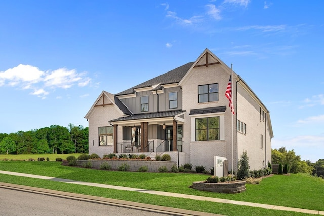3364 Sarah Bee Ln, Thompsons Station, TN 37179 - view of front of home featuring covered porch, a front lawn, a standing seam roof, and brick siding