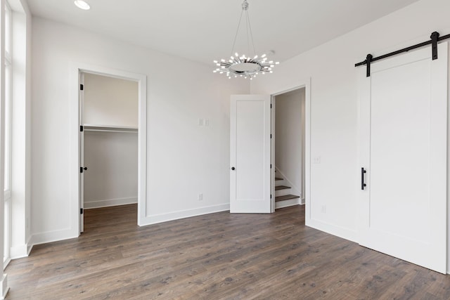 910 Youngs Ln Unit 4, Nashville, TN 37207 - unfurnished bedroom with dark wood-style flooring, a barn door, a walk in closet, a chandelier, and recessed lighting