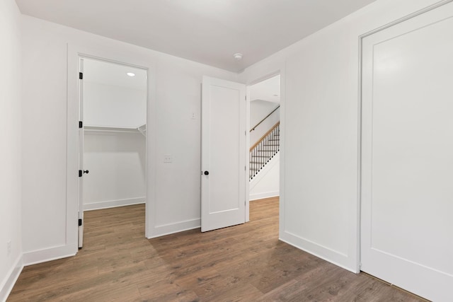 910 Youngs Ln Unit 4, Nashville, TN 37207 - unfurnished bedroom featuring a walk in closet, wood finished floors, and a closet