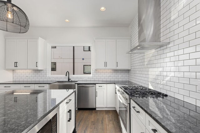 910 Youngs Ln Unit 4, Nashville, TN 37207 - kitchen with appliances with stainless steel finishes, wall chimney range hood, backsplash, white cabinetry, and recessed lighting