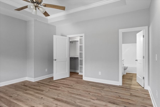 763 Potter Rd, Dickson, TN 37055 - unfurnished bedroom with ornamental molding, wood finished floors, a spacious closet, ensuite bathroom, and a closet