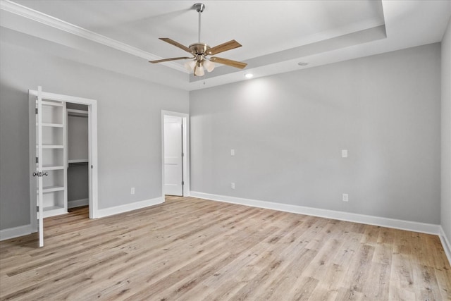 763 Potter Rd, Dickson, TN 37055 - unfurnished bedroom with a raised ceiling, light wood finished floors, a walk in closet, ceiling fan, and recessed lighting