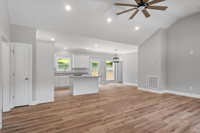 763 Potter Rd, Dickson, TN 37055 - kitchen featuring a ceiling fan, white cabinets, a kitchen island, light wood-type flooring, and open floor plan