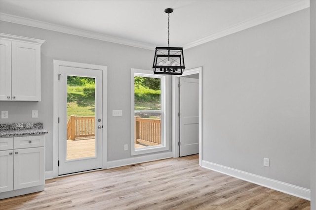 763 Potter Rd, Dickson, TN 37055 - unfurnished dining area with light wood-style flooring, ornamental molding, and a chandelier