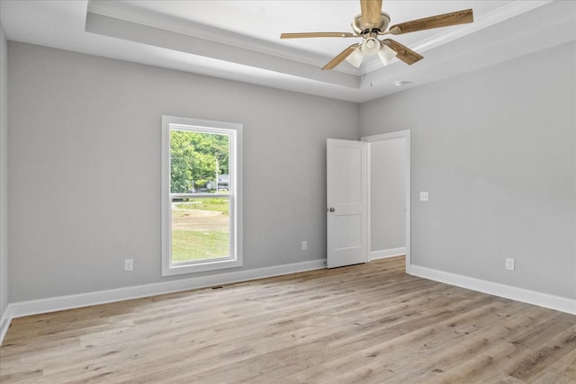 763 Potter Rd, Dickson, TN 37055 - unfurnished room featuring a tray ceiling, ornamental molding, wood finished floors, and a ceiling fan