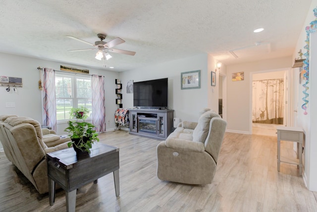 6117 Aedc Rd, Winchester, TN 37398 - living area featuring ceiling fan, a textured ceiling, light wood finished floors, recessed lighting, and a fireplace