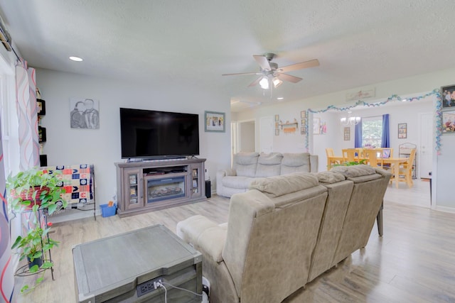 6117 Aedc Rd, Winchester, TN 37398 - living room with a ceiling fan, light wood-style flooring, a textured ceiling, recessed lighting, and a fireplace