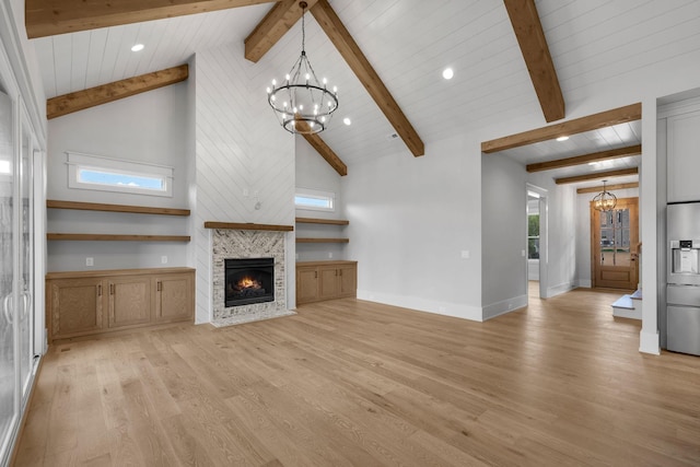 343 Circuit Rd, Franklin, TN 37064 - unfurnished living room with a chandelier, light wood-style flooring, a glass covered fireplace, a wood ceiling with exposed beams, and high vaulted ceiling
