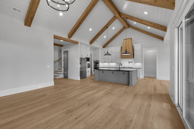 343 Circuit Rd, Franklin, TN 37064 - kitchen with beamed ceiling, white cabinets, light wood-style flooring, hanging light fixtures, and recessed lighting