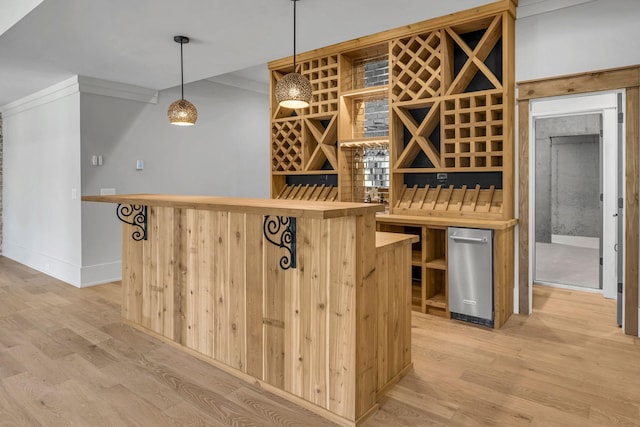 343 Circuit Rd, Franklin, TN 37064 - wine cellar featuring light wood-type flooring, ornamental molding, and a bar