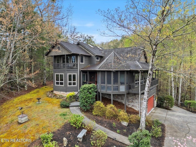 802 Stonegate Way, Townsend, TN 37882 - view of front of property featuring a sunroom, a shingled roof, driveway, a balcony, and a chimney