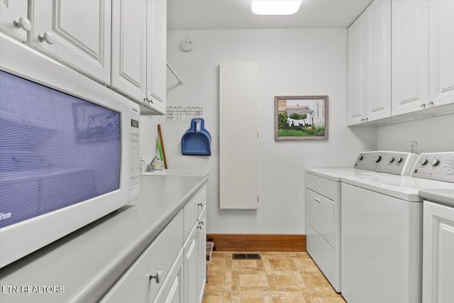 802 Stonegate Way, Townsend, TN 37882 - laundry area with washing machine and dryer, cabinet space, and stone finish flooring