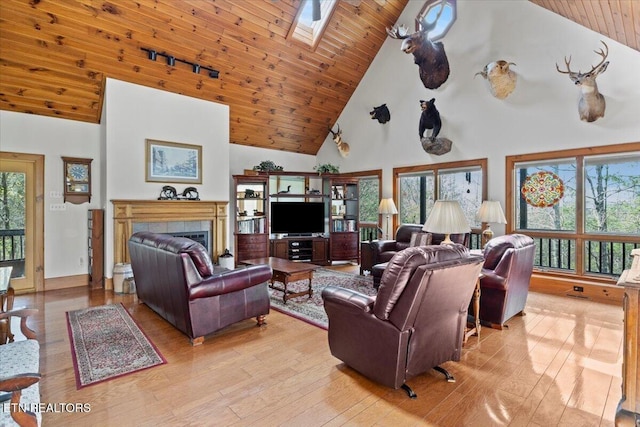 802 Stonegate Way, Townsend, TN 37882 - living area featuring a skylight, high vaulted ceiling, hardwood / wood-style floors, wood ceiling, and a tile fireplace