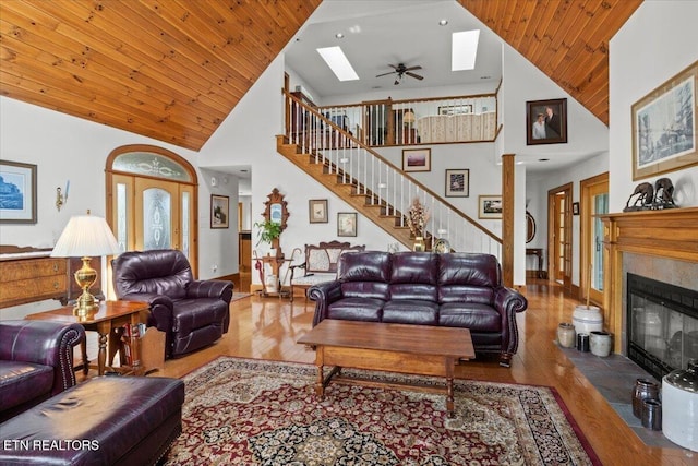 802 Stonegate Way, Townsend, TN 37882 - living room with high vaulted ceiling, wood finished floors, a skylight, stairway, and a glass covered fireplace