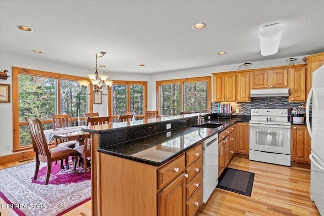 802 Stonegate Way, Townsend, TN 37882 - kitchen featuring white appliances, under cabinet range hood, a peninsula, a chandelier, and light wood finished floors
