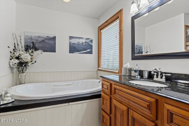 802 Stonegate Way, Townsend, TN 37882 - bathroom featuring vanity, a garden tub, and wainscoting
