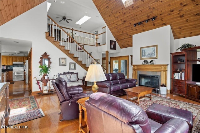 802 Stonegate Way, Townsend, TN 37882 - living room with high vaulted ceiling, wood ceiling, a premium fireplace, light wood-style floors, and a skylight