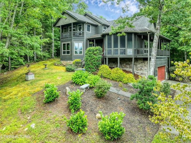 802 Stonegate Way, Townsend, TN 37882 - rear view of property featuring a balcony, roof with shingles, a garage, driveway, and a sunroom