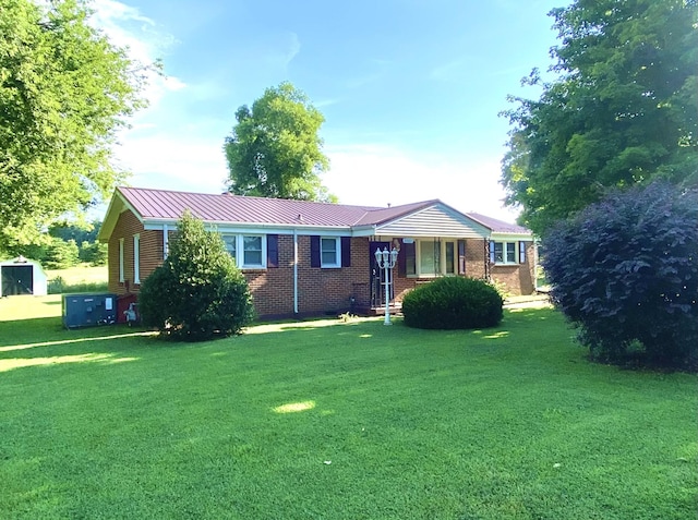 2001 Westwood Dr, Columbia, TN 38401 - ranch-style home with a front lawn, brick siding, a metal roof, and a storage unit