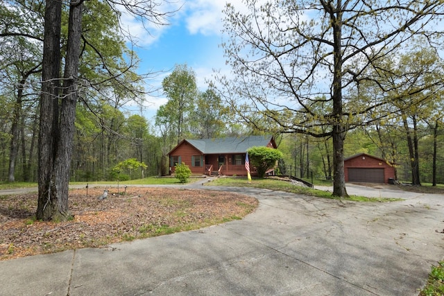 183 Jerry Smith Rd, Indian Mound, TN 37079 - view of front of house featuring covered porch, an outbuilding, and a detached garage