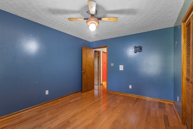 183 Jerry Smith Rd, Indian Mound, TN 37079 - spare room with a textured ceiling, wood finished floors, and ceiling fan