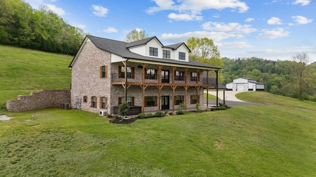 3945 Hartsville Rd, Lafayette, TN 37083 - rear view of house with an outdoor structure, a lawn, brick siding, and a detached garage