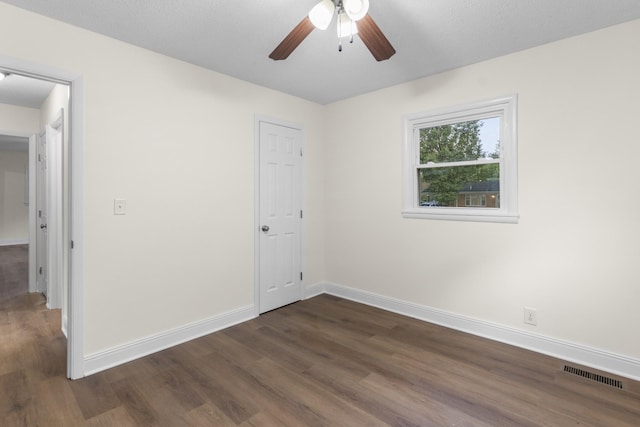 222 Jackson St, Lawrenceburg, TN 38464 - unfurnished bedroom with dark wood finished floors and ceiling fan