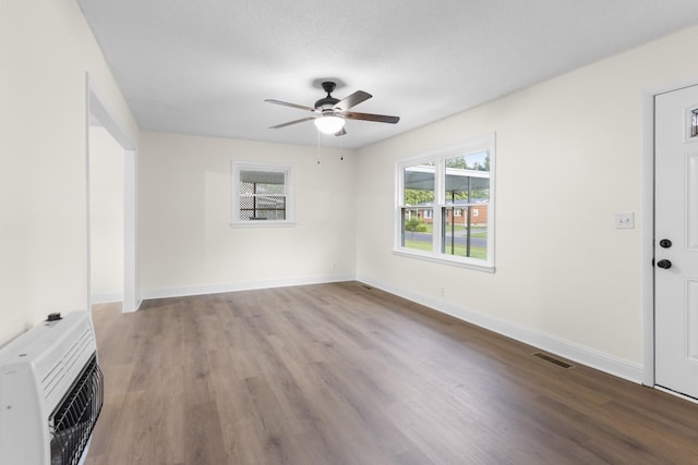 222 Jackson St, Lawrenceburg, TN 38464 - unfurnished living room with heating unit, a ceiling fan, and wood finished floors